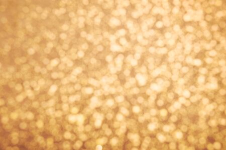 Golden glitter texture. Christmas expensive abstract background. Blured bokeh
