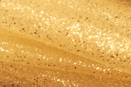 Golden glitter texture. Christmas expensive abstract background. Blured bokehの写真素材
