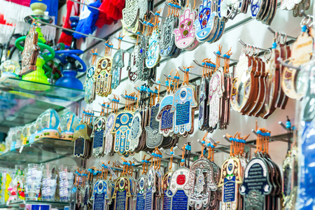 Different jewish souvenirs as Hamsa with Shalom (Peace) and other sale at the popular marketplace in Tel Aviv, Israel. Selective focusの写真素材