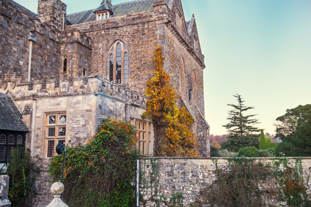 Part of a stone castle on a background of blue sky. Medieval britain architecture concept. Selective focus. copy spaceのeditorial素材