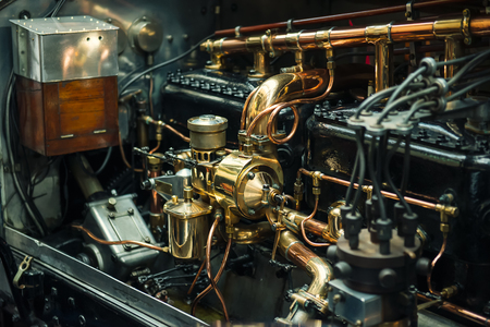 Close up view of posh and expensive vintage classic retro car detailed engine parts. Selective focus
