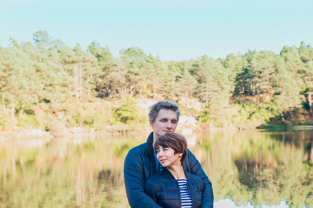 Two attractive dreamy people, couple in casual outfit at wild forest near water. Idyllic calm peaceful life style person freedom concept. Selective focus, copy spaceの写真素材