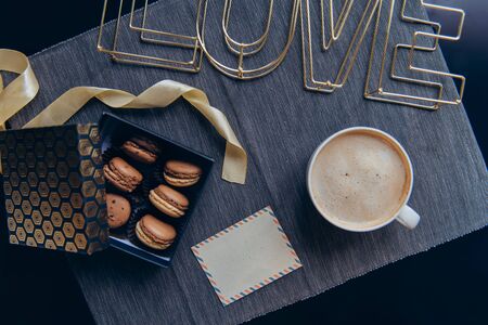 Top view Cozy breakfast for lover. Romantic morning in noir nordic style. Coffee cup, box with...