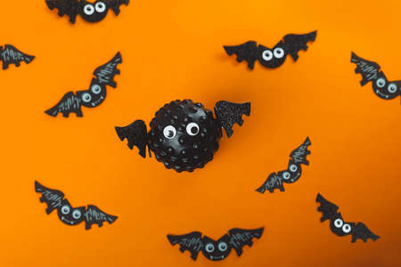 Model of Covid virus in the shape of a bat with flying bats in the background. Scariest hero in...