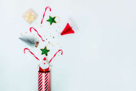 Top view collection of Christmas decorations flying from gift box. Santa, candy canes, christmas...
