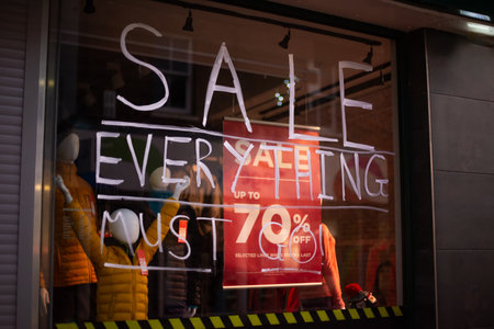 Handwrite message Sale everything on a glass of window case of fashion store outdoors. Big discount because of the store closing. Selective focus. Copy spaceの写真素材