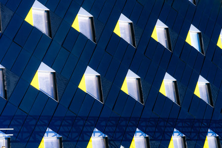 Abstract minimal style architecture background. Modern building facade detail. Geometric dark navy color exterior with windows. Modern building facade.の写真素材