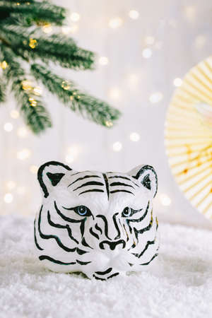 Tiger symbol and chinese bamboo paper fan with traditional chinese ornament. Chinese New Year of the Tiger 2022. Bokeh lights background. Vertical card. Copy space.の写真素材