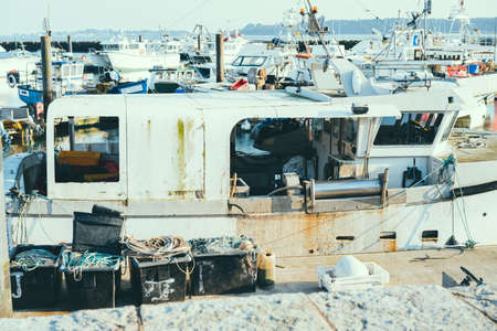 fishermans boat on off duty standing in marina quay. Selective focus, copy space.の写真素材