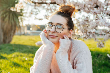 Portrait of young caucasian brunette hipster girl in glasses with pimpled on her face. Body positive...