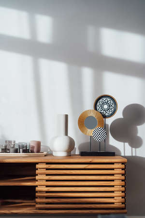 Vertical view of a modern minimalist Scandinavian style interior. Candles, ceramic vase and artistic...