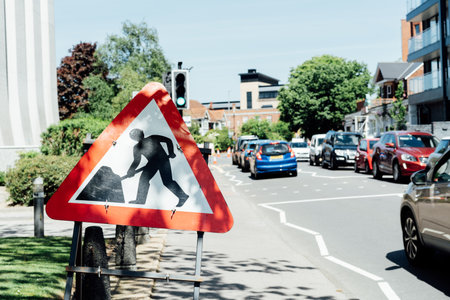 Road signs and roadworks along the side of a main traffic area. Traffic jam on the road. Selective...