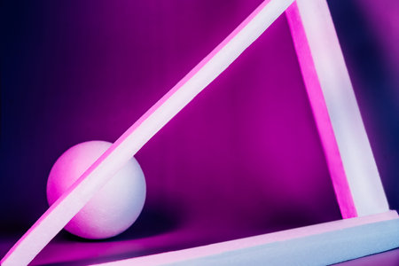 Modern product showcase with dark blue and purple neon light background. Geometrical shapes of ball...