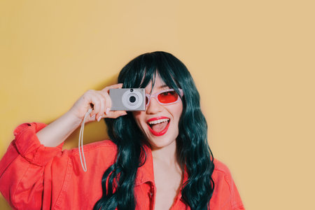 Cheeky shouting bright fashion girl with dark green long hair, bright red lips, top and sunglasses...