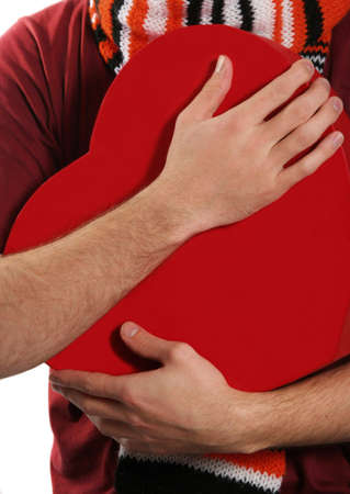 man holding his heart in handsの写真素材