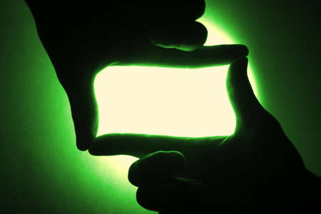 two male hands holding blank gesture on the bright green backgroundの写真素材