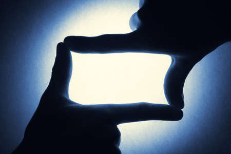 two male hands holding blank gesture on the bright blue backgroundの写真素材