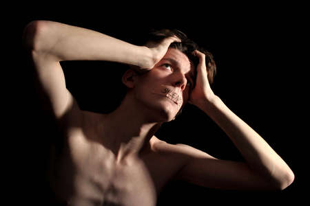 young man listening to the voice of godの写真素材