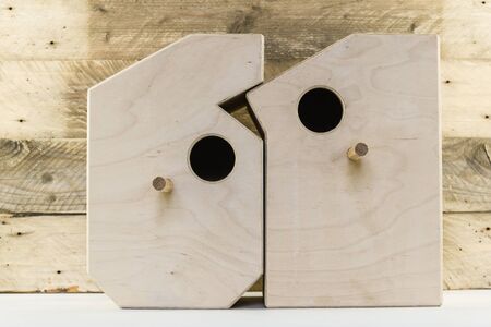 Wooden bird houses in shaped of numbers on a old antique rustic wooden planks backgroundの写真素材