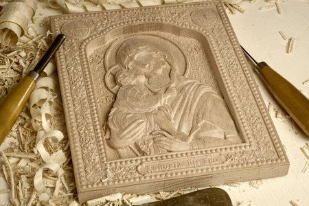 Wooden carved orthodox  icon of the of the Mother of God and child Jesus  on a white background.の写真素材