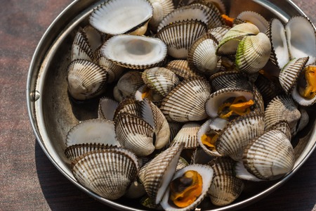 Sea shellfish cooked at a campfire on the beachの写真素材