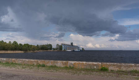 River terminal-elevator on the bank of the Kremenchug reservoir against a blue sky background, the village of Vitovo, Cherkasy regionの写真素材