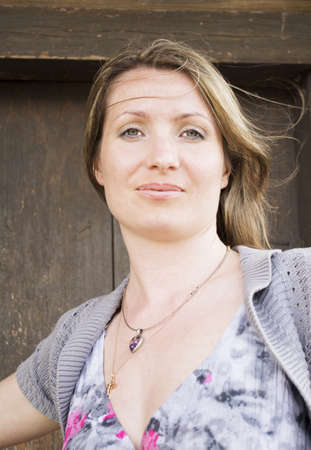 The woman photographed against the old wooden door  の写真素材