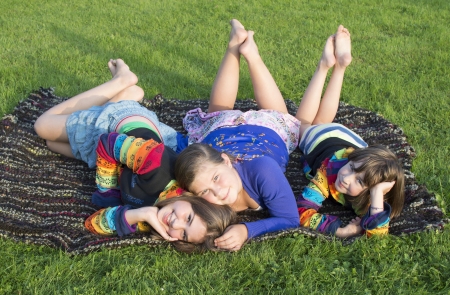 Girls have a rest on a grass の写真素材