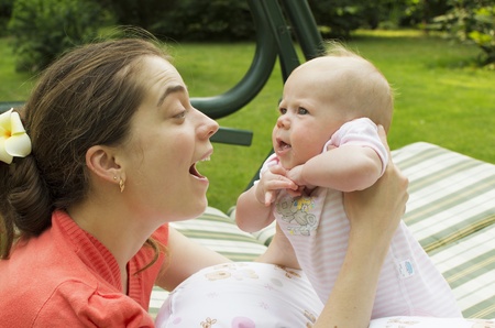 Young mother communicates with the 4th monthly baby の写真素材