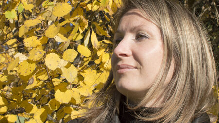 Portrait of the woman against autumn leaves の写真素材