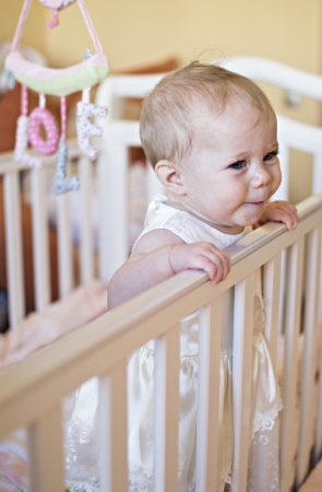 The baby of half a year costs in a bed の写真素材