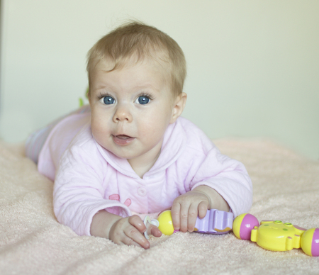 The baby of half a year lies on a stomach の写真素材