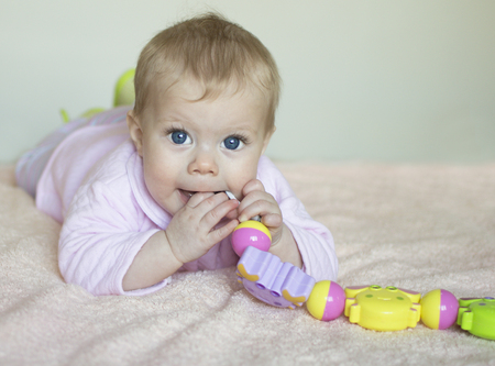 The baby of half a year sucks a toy の写真素材
