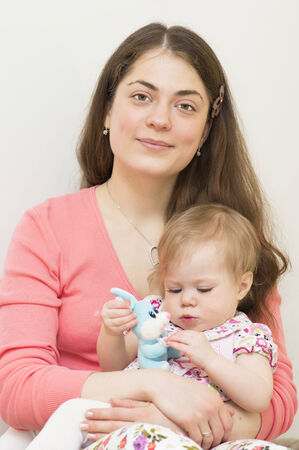 Young mother with the baby of 11 months old is looking directly の写真素材