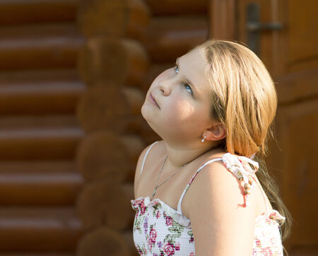 The beautiful girl of 11 years old is looking up.の写真素材