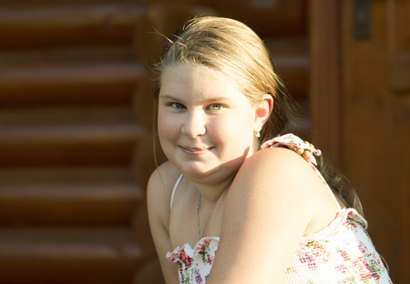 Thel girl of 11 years old is looking directly and joyfully smiles.の写真素材