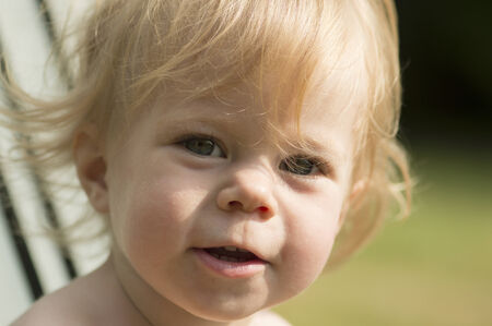 Girl of 1 year old is looking directly.の写真素材