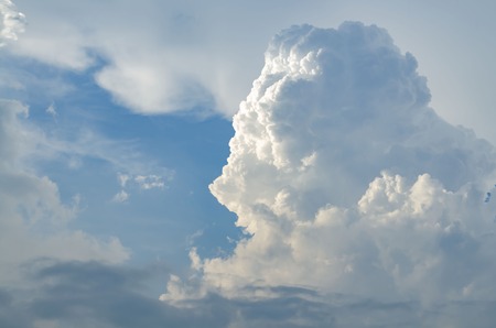 A large cumulus cloud illuminated on one side. Thunder Sky. Sun beams from the cloudsの写真素材