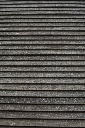 Old hammered planks covered with lichen. Vertical photoの写真素材