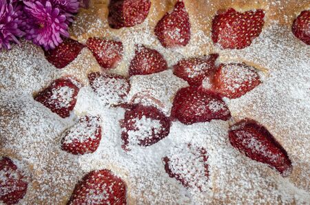 A feast with strawberries sprinkled with powdered sugar closeupの写真素材