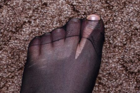 Black nylon tights or socks torn on the thumb