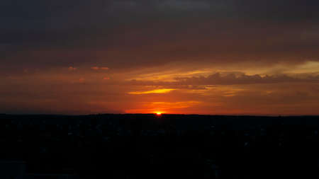 Bright colorful sunset. Dark sky with orange reflectionsの写真素材