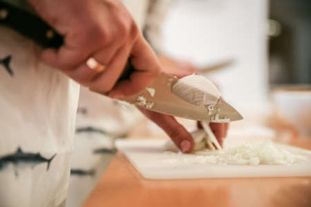 Cooking Classes  Instructor showing How Cutting onionの写真素材