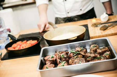 Cooking Teacher preparing sauce for meatの写真素材