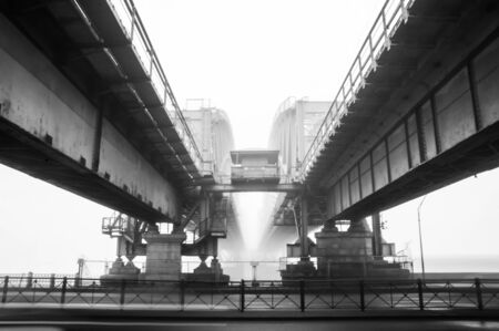 Railway bridge in a fog. black & white view from inside  of the bridge spanの写真素材