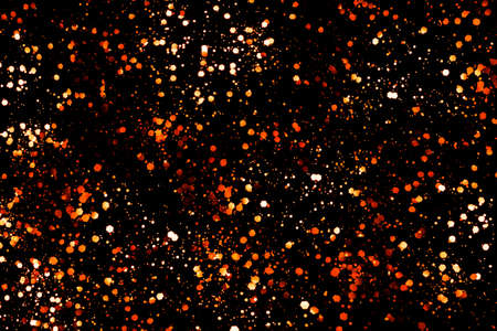 Golden and copper glitter sequins isolated on black Christmas background. Perfect backdrop for your design.の写真素材