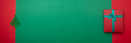 Festive background with toy in the form of Christmas tree and gift box. Christmas background with copyspace. Banner. Holiday conceptの写真素材