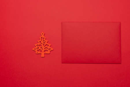 Festive background with Christmas tree toy, red envelope. Festive background with copyspace.の写真素材