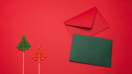 Festive background with Christmas tree toy, red and green envelope. Festive background with copyspace.の写真素材