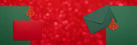 Festive background with two red and green envelopes. Festive background with copyspace. Banner.の写真素材